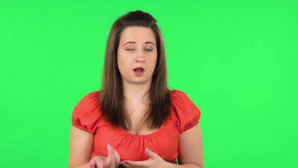 Portrait of Cute Girl Is Telling a Lot of Information. Green Screen