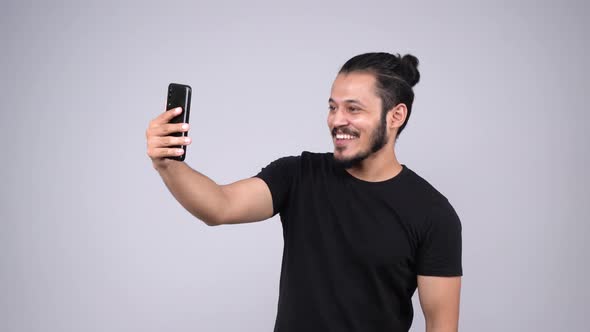 Happy young Indian man doing a video call