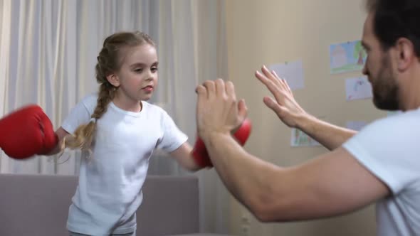 Excited Little Girl Boxing With Father, Showing Success Gesture, Sport Results