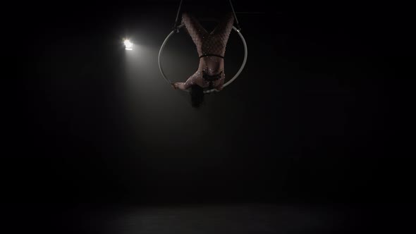 Young Girl Performs the Acrobatic Elements in the Air Ring