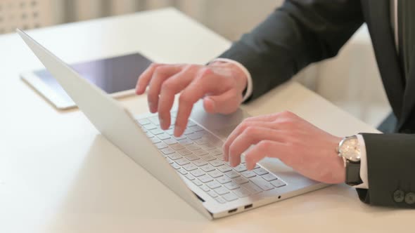Top View of Hands of Middle Aged Businessman Typing on Laptop