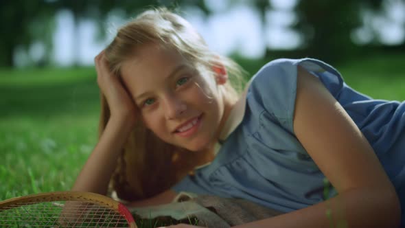 Smiling Girl Lying Blanket in Warm Sunlight Looking in Camera Close Up