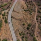 Car Drives on Winding Road Among Scrublands in Highland - VideoHive Item for Sale