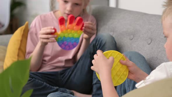 Kids Playing with Pop It Sensory Toy