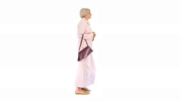 Attractive Intelligent Senior Woman Walking on White Background