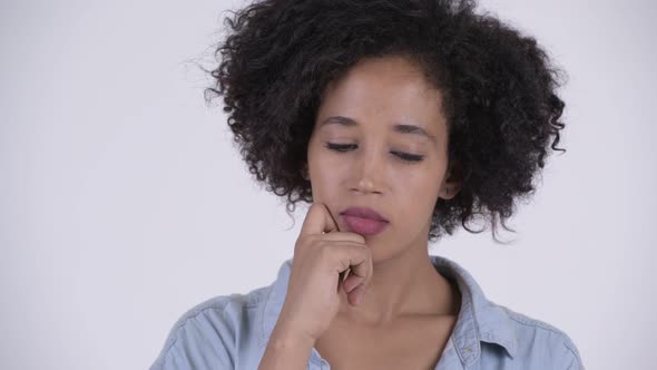 Face of Young Serious African Woman Thinking and Looking Down