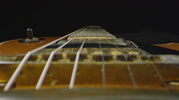 Macro Shot Through an Electric Guitar That Is Laying Down
