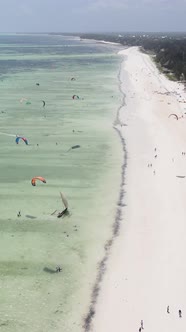 Vertical Video Kitesurfing Near the Shore of Zanzibar Tanzania