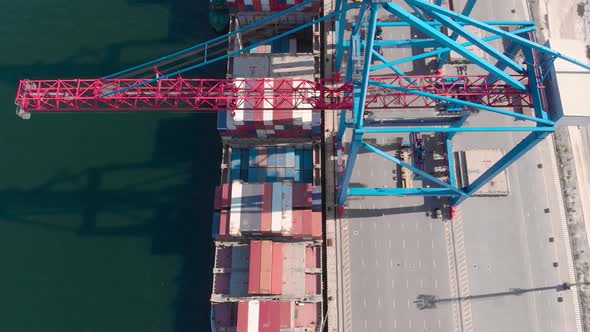 Drone Flying Over a Container Ship During Cargo Operations Over the Customs Area