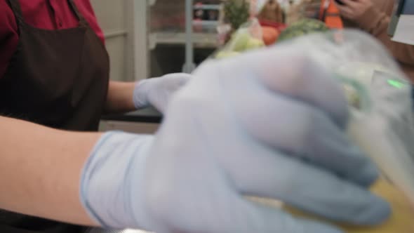 Unrecognizable Cashier Hands Scanning Food Products