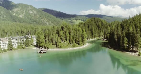 Aerial Drone Flight Establisher Over Lake with Clouds and Forest