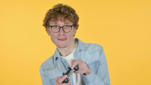 Redhead Young Man Playing Video Game Yellow Background