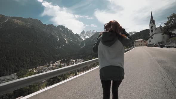 Slow Motion Shot of Happy Young Woman Spinning and Running in the Dolomites Northern Italy in the