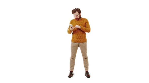 Middleaged Brunet Bearded Man Looking at His Phone and Happily Gesturing White Background Isolated
