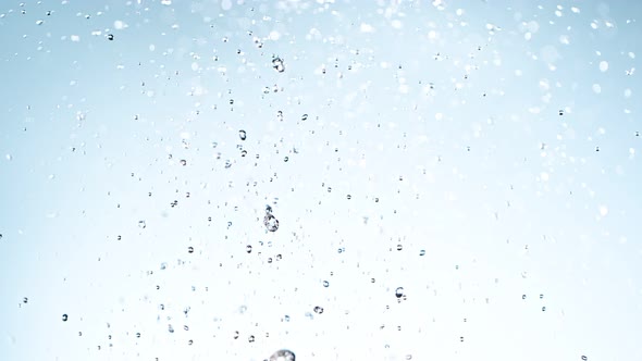 Super Slow Motion Shot of Water Splash on Light Blue Background at 1000Fps