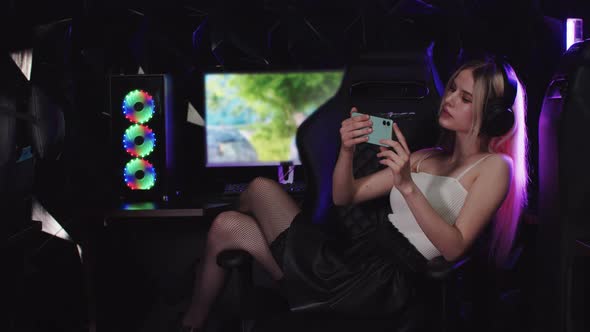 Young Blonde Attractive Gamer Woman Taking a Selfie in Gaming Club