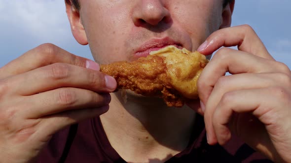 Young Man Eating Fat Fried Chicken