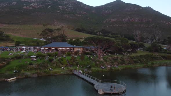 Drone shot of a vineyard in Cape Town - drone is reversing from the restaurant and outside areal. Sn