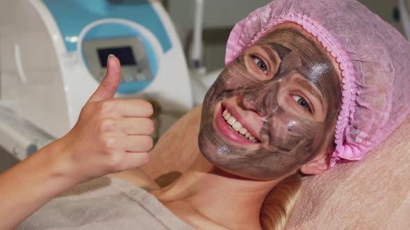 Happy Woman Showing Thumbs Up While Having Black Mask on Her Face