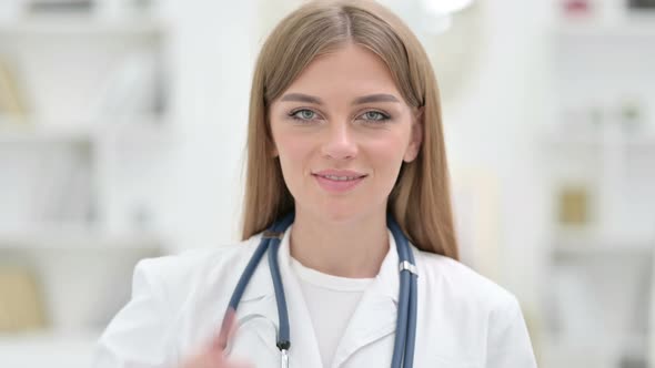 Portrait of Positive Young Doctor Showing Thumbs Up Sign 