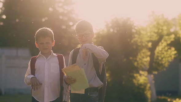 Kids in School Uniform with Bags Stand Holding Books