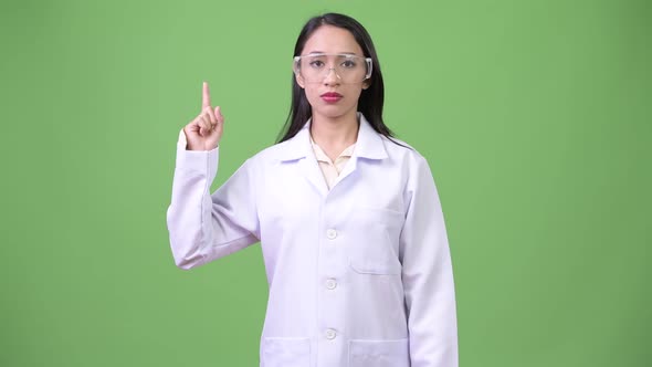 Young Beautiful Asian Woman Doctor Wearing Protective Glasses