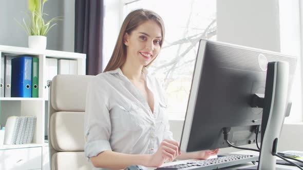 Young Woman Works at Home Office Using Computer.