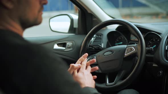 Man Driving in Innovative Automated Car Using Selfparking Autopilot for Parking on Parking Lot