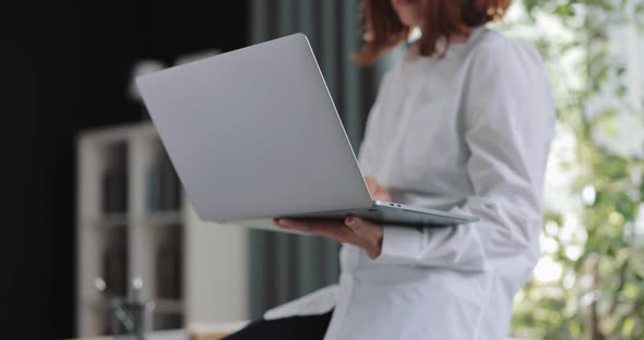 Woman Holding Laptop in Hands