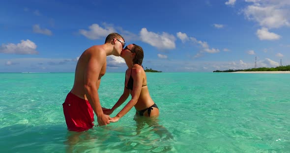 Beautiful couple married on vacation enjoy luxury on beach on sunny white sandy background 4K