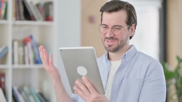 Portrait of Video Call on Tablet By Man in Glasses