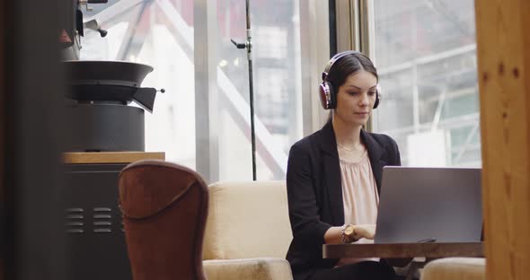 Caucasian Businesswoman Login to a Video Conference in a Coffee Shop