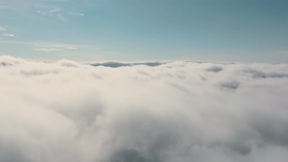 Aerial View Flying Over Dense Low Cloud During the Day