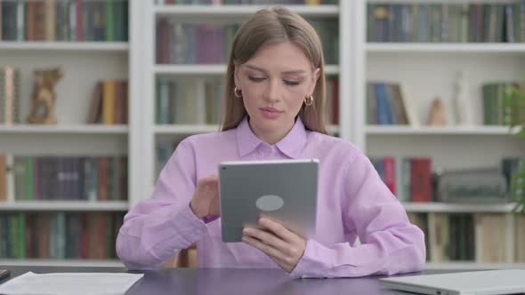 Woman Using Tablet While Sitting in Office