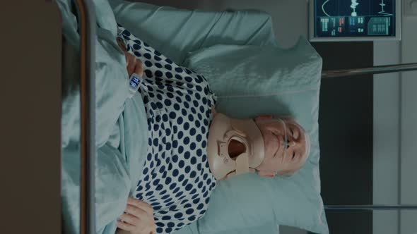 Vertical Video Portrait of Sick Elder Patient with Cervical Collar on Neck