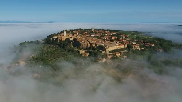 Old Italian City on Top of Hill in Fog Tuscany