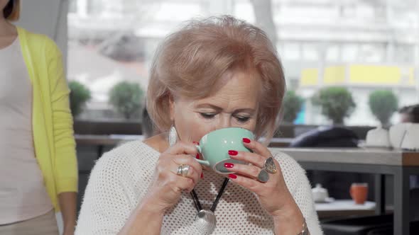 Senior Woman Meeting Her Adult Daughter at the Local Coffee Shop