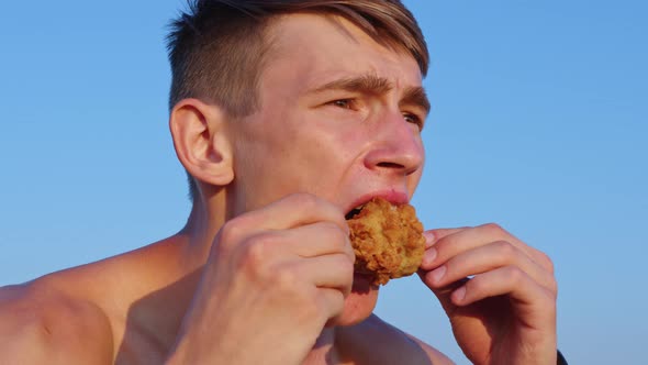 Young Man Eating Fat Fried Chicken