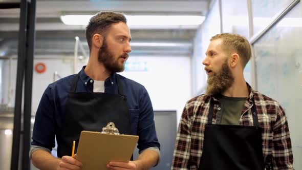 Brewers with Clipboard at Brewery or Beer Plant