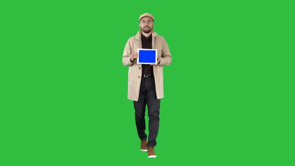 Attractive man holding tablet with blue key screen mockup