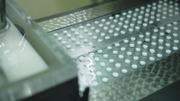 The Packaged Pills Move Along the Conveyor Belt