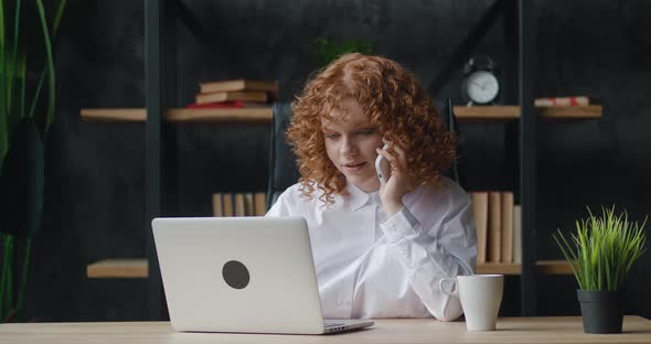 Happy Young Business Woman Professional Talking on Phone Using Laptop Computer Sitting at Office