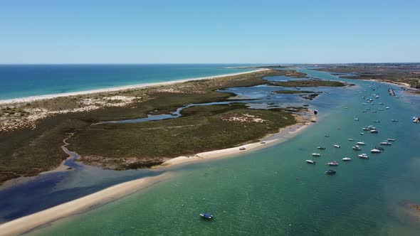 Aerial View Of Beautiful River And Coastline In Tavira, Algarve, Portugal At Summer. drone descend