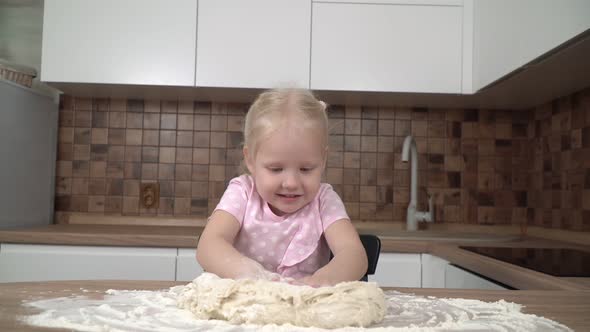 Little Girl with Dough in the Kitchen