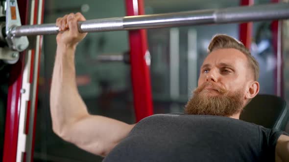 HalfBody Shot of Attractive Male Pilot Doing a Bench Press