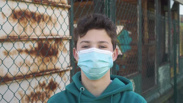 Portrait of a happy young man in a protective medical mask.