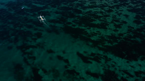 Boat in the ocean over coral reef