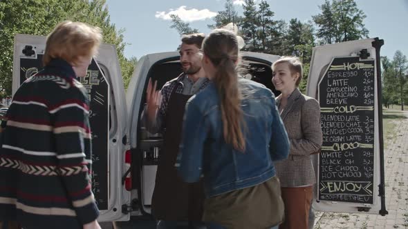 Friends Ordering from Mobile Coffee Van