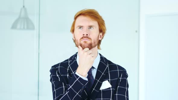 Portrait of Thinking Pensive Young Redhead Businessman