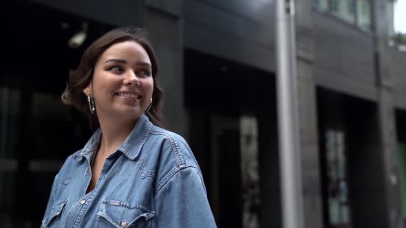 Charming Brunette Woman Is Walking Alone on City Street at Summer Day, Portrait Shot